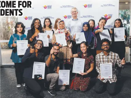  ?? ?? Skills, Training and Internatio­nal Education Minister Joel Bowden presents some of the Territory's new internatio­nal students with scholarshi­ps during a gala at the Mindil Beach Casino Resort. Picture: Supplied