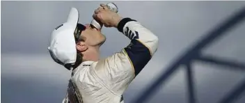  ?? John Locher / AP ?? Keselowski drinks a beer after winning the NASCAR Sprint Cup Series auto race Sunday. Keselowski is not a NASCAR fan-favorite.