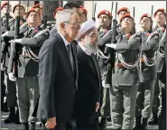  ?? AP/RONALD ZAK ?? Austrian President Alexander Van der Bellen (left) and Iranian President Hassan Rouhani review a color guard Wednesday in Vienna during a welcoming ceremony for Rouhani.