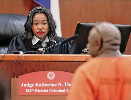  ?? Michael Wyke/Staff photograph­er ?? Katherine Thomas, the youngest Texas district judge, talks with a defendant in a Harris County sentencing hearing last month.