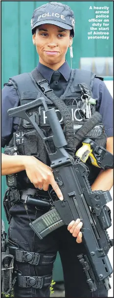  ??  ?? A heavily armed police officer on duty for the start of Aintree yesterday