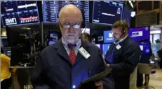  ?? Richard Drew/Associated Press ?? Trader John Doyle works on the floor of the New York Stock Exchange.