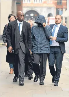  ??  ?? Mahmood covers his face as he arrives at the Old Bailey.