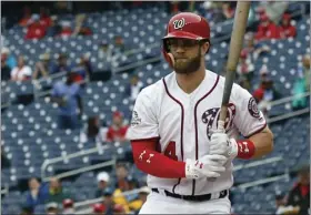  ??  ?? Washington Nationals’ Bryce Harper wears glasses to bat during the first inning of the first baseball game of a doublehead­er against the Los Angeles Dodgers at Nationals Park on Saturday in Washington. AP PHOTO/ALEX BRANDON