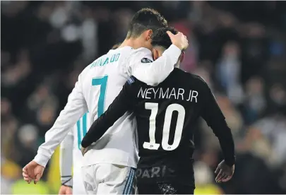  ??  ?? Cristiano Ronaldo, left, gives a hug to PSG’s Neymar after Real Madrid’s 3-1 win in their last 16, first-leg tie