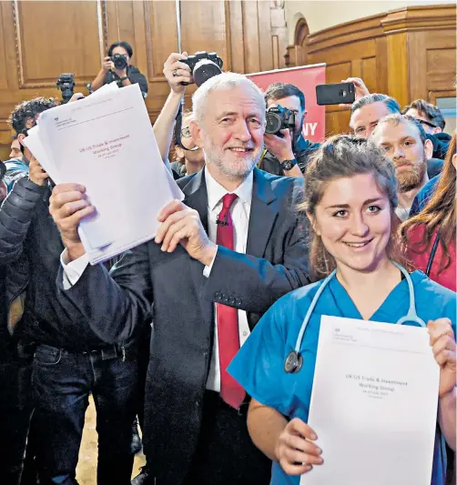  ??  ?? Jeremy Corbyn poses with his ‘evidence’ that the NHS is for sale – a paper that only mentions the service four times in its 451 pages