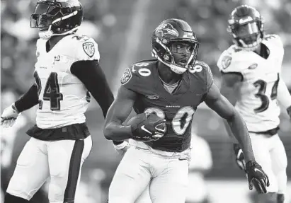  ?? GAIL BURTON/AP ?? Ravens wide receiver Miles Boykin runs a play during training camp Saturday in Baltimore. He’s vying for a starting role.