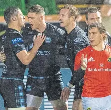  ??  ?? Glenn Bryce, centre, celebrates his try for Glasgow.