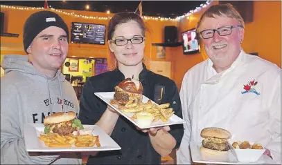  ?? LAWRENCE POWELL ?? Cody Taylor, Michelle Friel, and John Bartlett with their burgers and sides during the friendly competitio­n at The Capitol Pub in Middleton Feb. 28 as they came up with an entry for the upcoming Campaign for Kids Burger Wars. Friel’s Big Popper won the...
