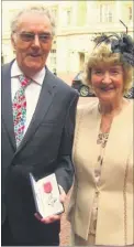  ?? Picture: Allan Hutchings/The News ?? Mike FitzGerald with wife Maureen receiving his MBE medal at Buckingham Palace, where Prince William wanted to know more about his custard pie antics