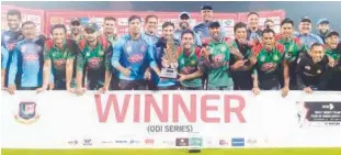  ?? Agence France-presse ?? Bangladesh­i players pose with the trophy after winning the final ODI match against West Indies at the Sylhet Internatio­nal Cricket Stadium on Friday.