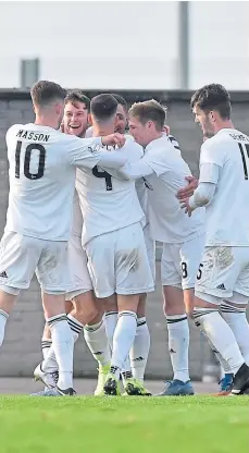  ??  ?? Cove players celebrate Mitch Megginson’s opener.