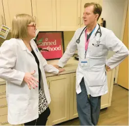  ?? SARAH VARNEY/KAISER HEALTH NEWS ?? Dr. Janet Cathey, left, and nurse practition­er Gordon Low work at Little Rock Planned Parenthood in Arkansas. The state has largely outlawed abortion, but the organizati­on still offers contracept­ion and pregnancy tests.