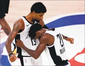  ?? Mike Ehrmann Getty Images ?? PAUL GEORGE and Patrick Beverley react after overcoming a double-digit deficit to beat Denver in Game 3 of their second-round series. George scored a team-high 32 points as the Clippers took a 2-1 series lead.