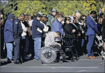  ?? FRANCINE ORR / LOS ANGELES TIMES ?? The crowd — including Anthony Mascaro, 41, (middle in wheelchair) — observes a moment of silence at the Inland Regional Center in San Bernardino, Calif., to remember the victims of the attack that occurred a year earlier.