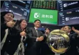  ?? BLOOMBERG ?? Wang Yi, founder of LAIX Inc, center, rings a ceremonial bell during the company’s initial public offering on the floor of the New York Stock Exchange in New York.