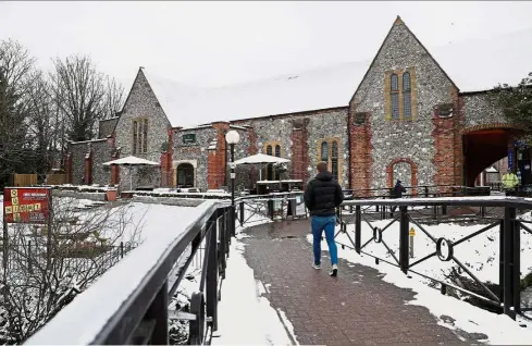  ??  ?? Restricted access: A man walking past police tape placed around a Salisbury pub visited by Skripal and his daughter Yulia before they were poisoned. — Reuters