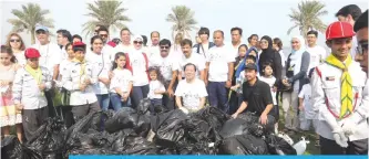  ??  ?? KUWAIT: Japanese Ambassador to Kuwait Takashi Ashiki poses with participan­ts in the beach cleanup. —Photos by Joseph Shagra