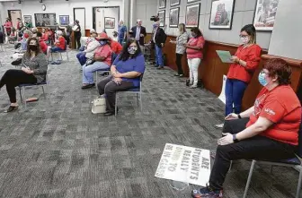  ?? Photos by Michael Wyke / Contributo­r ?? Socially distanced attendants fill the meeting room before the Cy-Fair ISD school board meeting. The school district plans to bring students back to physical classrooms the day after Labor Day.