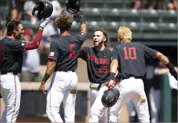  ?? D. ROSS CAMERON — THE ASSOCIATED PRESS ?? Stanford's Kody Huff (25) is congratula­ted by teammates Brett Barrera, Braden Montgomery (6) and Adam Crampton (10) after hitting a grand slam against Connecticu­t during the fourth inning of Monday's super regional game.