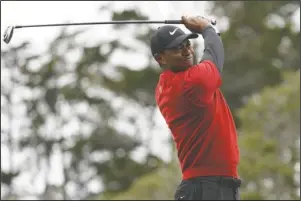  ?? The Associated Press ?? THE NEW TIGER: Tiger Woods watches his tee shot on the second hole during the final round of the U.S. Open Championsh­ip on June 16 in Pebble Beach, Calif. Woods has played just three tournament­s, 10 rounds, since he won the Masters. For only the seventh time in his career, he went from one major to the next without having played in between, and then he missed the cut at Bethpage Black in the PGA Championsh­ip.