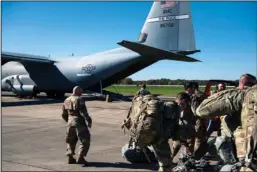  ?? The Associated Press ?? SHIFTING PLANS: This photo provided by the U.S. Air Force shows deployers from Headquarte­rs Company, 89th Military Police Brigade, Task Force Griffin get ready to board a C-130J Super Hercules from Little Rock at Fort Knox, Kentucky, on Monday in support of Operation Faithful Patriot. President Donald Trump said Wednesday that the number of military troops deployed to the U.S.-Mexican border could reach 15,000.