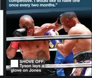  ??  ?? SHOVE OFF: Tyson lays a glove on Jones
