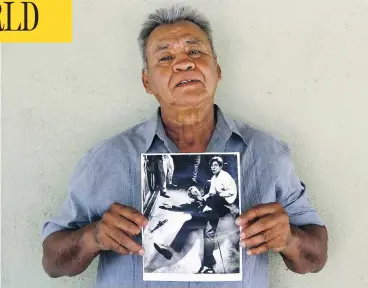  ?? JUD ESTY-KENDALL / STORYCORPS VIA AP ?? Juan Romero holds a Los Angeles Times photograph that shows him with Sen. Robert F. Kennedy moments after Kennedy was shot at the Ambassador Hotel in Los Angeles in 1968. Romero died Monday at age 68.