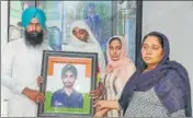  ?? HT PHOTO ?? Sepoy Gurbinder Singh’s family with his photo at their home in Tolowal village near Sunam in Sangrur.