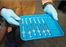  ?? WILFREDO LEE / AP FILE ?? In this Jan. 6 file photo, syringes containing the COVID-19 vaccine are displayed in Pompano Beach, Fla.