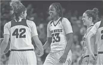  ??  ?? ASU's Charnea Johnson -Chapman (33) celebrates with Kianna Ibis (42) during the second half against Stanford at Wells Fargo Arena on Sunday in Tempe. PATRICK BREEN/THE REPUBLIC