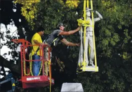  ?? BRUCE NEWMAN — THE OXFORD EAGLE VIA AP ?? A Confederat­e statue at the University of Mississipp­i is lowered to the ground Tuesday as part of the process to move it to the Confederat­e Soldiers Cemetery on campus.