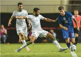  ?? JOSE BRETON/AP ?? U.S. midfielder Christian Pulisic, right, duels for the ball with Saudi Arabia’s Abdulelah Ali Alamri during an internatio­nal friendly Tuesday night in Murcia, Spain.