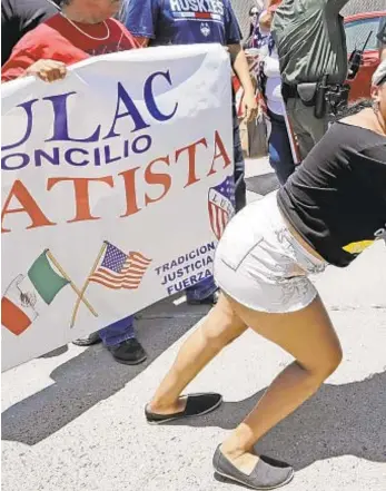  ??  ?? Demonstrat­or Martha Mercado tries to stop a bus with immigrant children onboard outside the U.S. Border Patrol Central Processing Center on Saturday in McAllen, Texas.