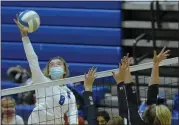  ??  ?? Chloe Cole (8) of Utica Eisenhower goes for the kill as Stoney Creek’s Olivia O’Dwyer, left, and Ella Markevics go up for the block Monday.