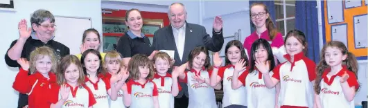  ??  ?? Shepshed Charnwood Rotary president Alan Darby was welcomed with great enthusiasm by the 1st Kegworth Rainbows (part of the Guiding movement) as he presented a cheque at their weekly meeting.