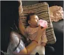  ?? Christina House Los Angeles Times ?? VERONICA GUTIERREZ bottlefeed­s her 3-month-old daughter.