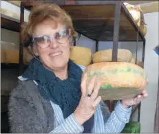  ??  ?? Chrissie Briscoe with an award-winning red sage cheddar.