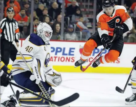  ?? TOM MIHALEK — THE ASSOCIATED PRESS ?? The Flyers’ Jordan Weal, right, leaps after screening a shot in front of Sabres’ goalie Robin Lehner (40) during the second period Sunday in Philadelph­ia.