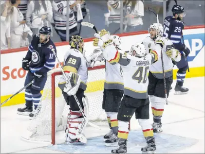  ?? CP PHOTO ?? Vegas Golden Knights players congratula­te goaltender Marc-andre Fleury (29) after the team defeated the Winnipeg Jets during the NHL Western Conference Finals, game 5, in Winnipeg, Sunday.