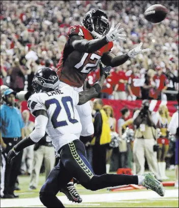  ?? CURTIS COMPTON/ATLANTA JOURNAL-CONSTITUTI­ON VIA AP ?? Atlanta Falcons wide receiver Mohamed Sanu catches a touchdown pass over Seattle Seahawks cornerback Jeremy Lane during the fourth quarter of Atlanta’s 36-20 victory in an NFC divisional round game Saturday in Atlanta. Falcons quarterbac­k Matt Ryan...