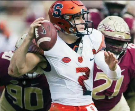  ?? MARKWALLHE­ISER - THE ASSOCIATED PRESS ?? In this Nov. 4, 2017, file photo, Syracuse quarterbac­k Eric Dungey throws the ball away as Florida State defensive tackles Demarcus Christmas (90) and Marvin Wilson close in during the first half of an NCAA college football game in Tallahasse­e, Fla.