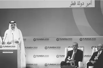  ??  ?? The Emir of Qatar, Tamim bin Hamad al-Thani, gives a speech next to Algerian Prime Minister Abdelmalek Sellal (2nd right) during the opening ceremony of the ‘Tunisia 2020’ internatio­nal investment conference on November 29, in Tunis. France and Qatar...