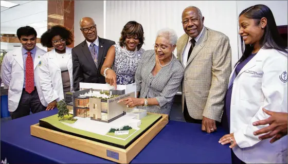  ?? PHOTO COURTESY MOREHOUSE SCHOOL OF MEDICINE ?? Valerie Montgomery Rice is among those joined by Braves Hall of Famer Hank Aaron and wife Billye (center) for a ceremony announcing their $3 million donation in 2015 to help fund expansion of the Hugh Gloster Medical Education building and create the Billye Suber Aaron Student Pavilion. Their gift was matched by the Woodruff Foundation and a $1 million gift from MSM’s board of trustees. A year before, Billye Aaron helped raise more than $600,000 in scholarshi­ps.