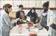  ?? ANDREAS SOLARO / AGENCE FRANCE-PRESSE ?? Women migrants (from second left) Eunice from Nigeria, Najiba from Iraq and Hawa from Gambia attend a cooking lesson in Sant’ Alessio.