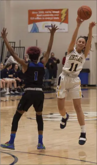  ?? JEN FORBUS — FOR THE MORNING JOURNAL ?? Kirtland guard Julia Camino passes past Lutheran East’s Dariah Kirksey on Feb. 27.