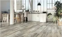  ??  ?? This glazed porcelain stoneware replicates the look of real wood planks while offering the convenienc­e and durability of porcelain tiles. Installati­on is key, and it’s important that floors be straight and level.