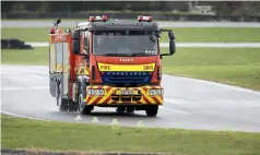  ?? MURRAY WILSON/STUFF ?? Not as sporty as the vehicles usually speeding around Manfeild raceway, but the skills are just as sharp for the firefighte­rs trying to keep control of the 10-tonne trucks.