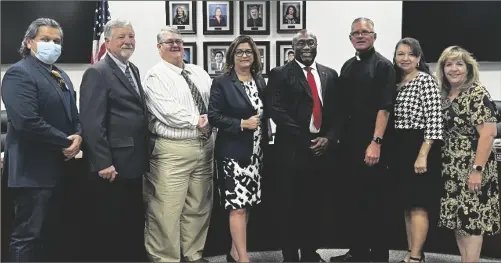  ?? ?? Dr. Lennor Johnson (fourth from right) is shown here following the Imperial Valley College board of trustees’ decision on Monday evening to select him as the next superinten­dent and president of IVC. Also pictured (from left)le are IVC trustees Rom Medina, Jerry Hart, Steve Taylor, Karla Sigmond, Mark Edney, Isabel Solis and Hortencia Armendariz.