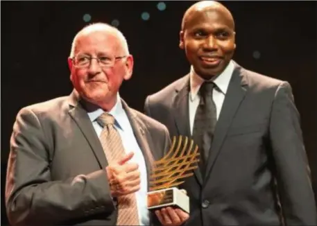  ??  ?? Brother Colm O’Connell receiving the World Athletics Coaching Achievemen­t Award from three-time world champion and former 800m world-record holder Wilson Kipketer at the IAAF World Athletics Awards ceremony.